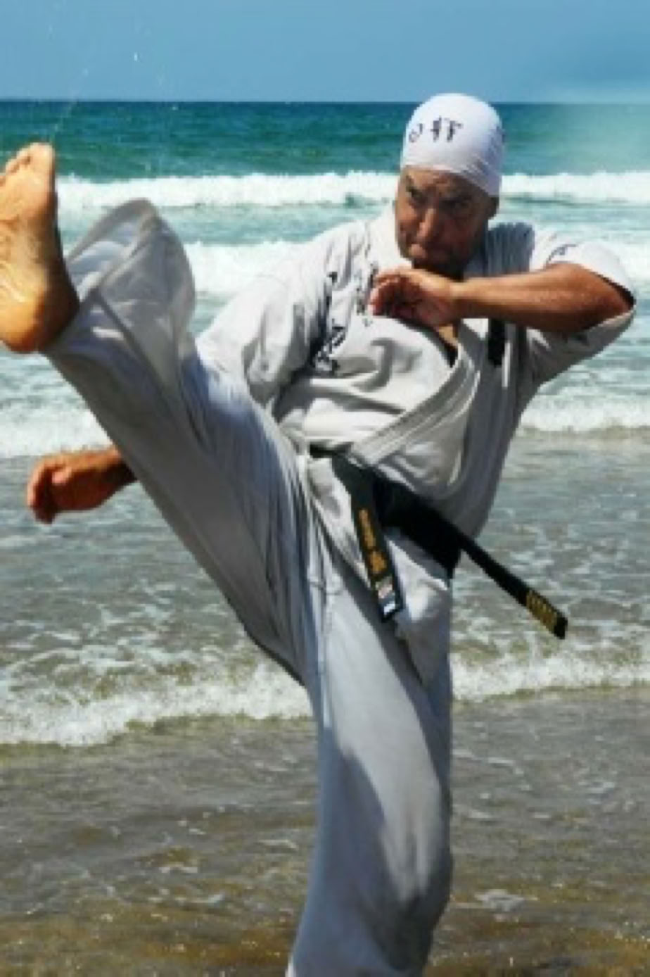 Sensei Soussi practicing Mae geri on the beach.